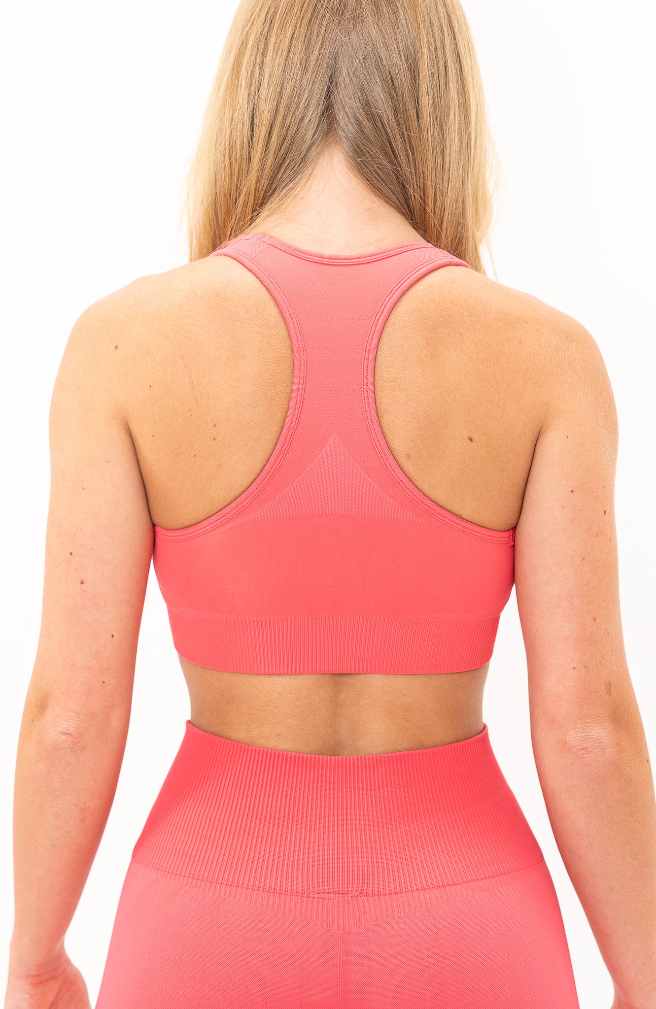 V3 Apparel Women's seamless Limitless training sports bra in coral pink with removable padded cups and strap for gym workouts training, Running, yoga, bodybuilding and bikini fitness.